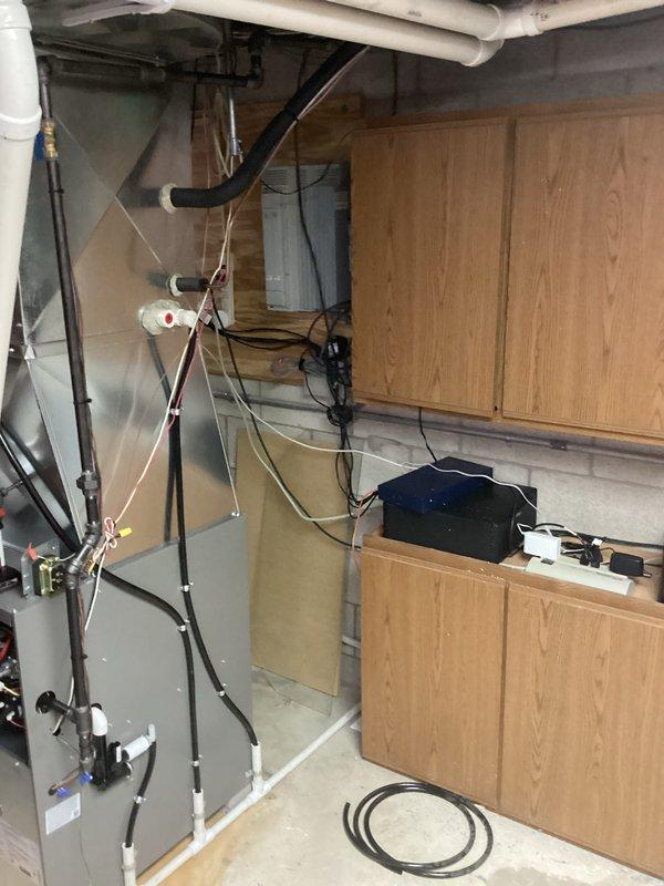 Completed furnace installation in basement utility area with all required permits and electrical work. New HVAC unit was positioned and secured on subfloor, with all electrical connections, control boards, and wiring properly installed and terminated according to manufacturer specifications. Gas piping, condensate drainage, and venting systems were connected and tested for proper operation, ensuring the system is fully functional and ready for use.