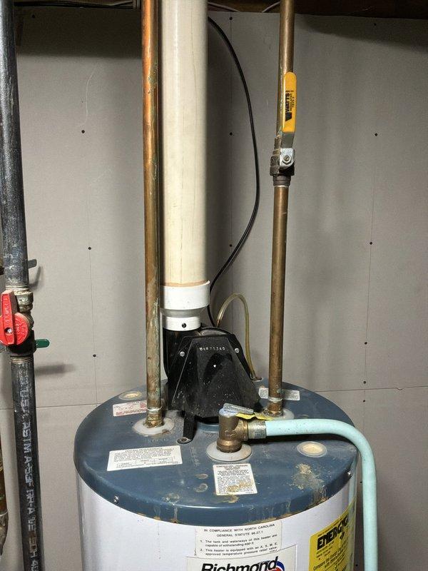 Evaluated existing Richmond 40-gallon power vent water heater nearing end of service life in basement utility area. Documented current installation including copper supply lines, gas connections, venting system, and surrounding plumbing infrastructure to provide accurate replacement estimate.