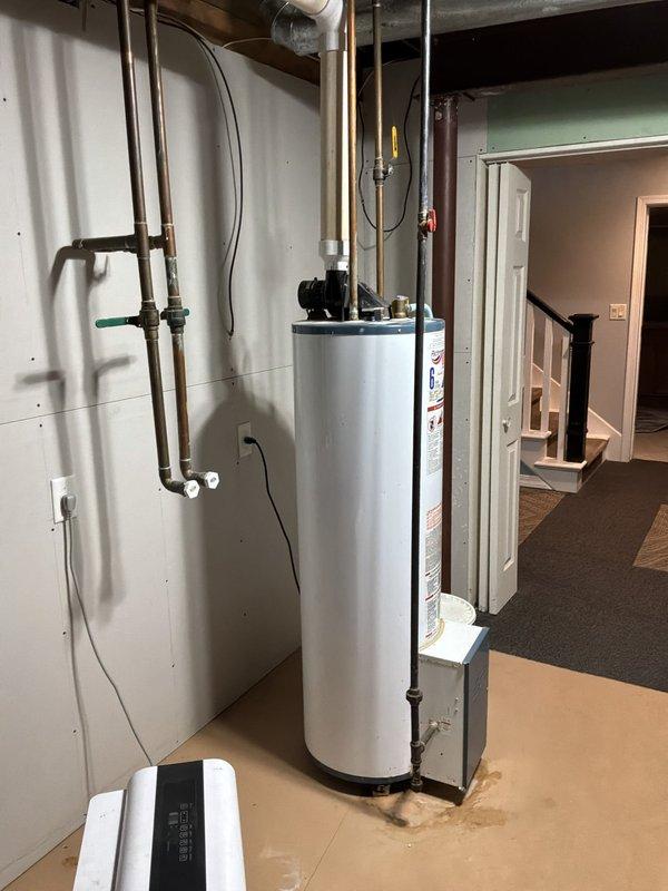 Evaluated existing Richmond 40-gallon power vent water heater nearing end of service life in basement utility area. Documented current installation including copper supply lines, gas connections, venting system, and surrounding plumbing infrastructure to provide accurate replacement estimate.