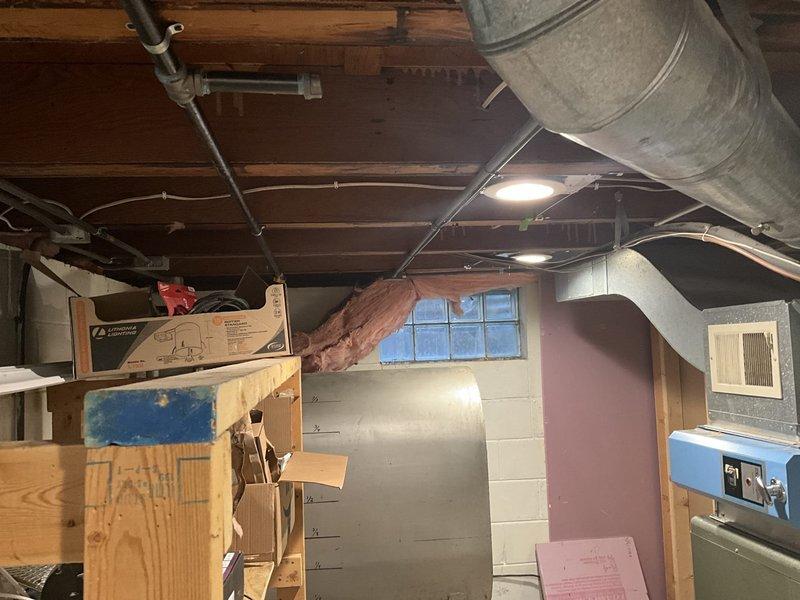 Conducted on-site assessment of existing oil-fired furnace system in basement mechanical room to provide estimate for conversion to gas-fired heating system. Evaluated current ductwork configuration, including existing metal supply and return plenums, and documented equipment layout and available space for new gas furnace installation. Confirmed gas line is already run to the location, simplifying the conversion process. Photographed existing HVAC equipment, ductwork connections, and mechanical room layout to prepare accurate replacement estimate and verify compatibility with new gas furnace specifications.