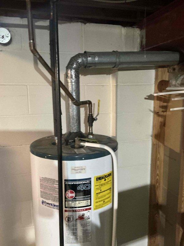 Conducted comprehensive assessment of residential HVAC system and water heater for replacement estimate. Evaluated existing furnace unit with metal ductwork, air conditioning system, and standard residential water heater with venting configuration in basement utility area. Documented current equipment specifications, installation conditions, and photographed existing setup including water heater with copper piping connections, flexible vent ductwork, furnace with condensate drain line to floor drain, and overall system layout for replacement proposal preparation.