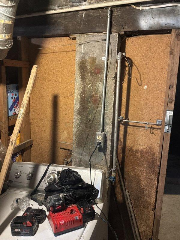 Conducted on-site assessment of residential plumbing system requiring partial pipe replacement in basement utility area. Evaluated existing infrastructure where walls were already opened, revealing mix of copper, PVC, and gray piping systems running throughout exposed ceiling joists. Identified remaining sections of piping requiring replacement to bring system up to code, while noting that majority of piping had already been updated. Documented current configuration including water heater connections, drain lines, and supply lines to provide comprehensive estimate for completing remaining pipe replacement work.