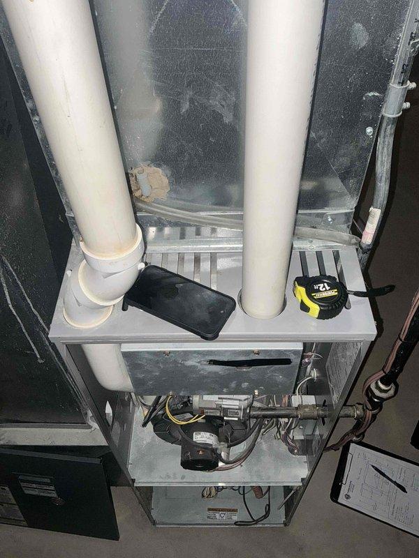 Responded to emergency furnace call and conducted comprehensive equipment assessment. Upon inspection, identified critical failure conditions including severely rusted burner box assembly and compromised heat exchanger showing signs of deterioration. Documented existing system configuration consisting of gray cabinet-style furnace with white PVC venting, integrated humidifier unit, and associated air handling equipment in basement mechanical room. Provided detailed replacement estimate for complete furnace system due to unsafe operating conditions of primary heat exchanger and burner components that pose potential safety hazards and cannot be effectively repaired.