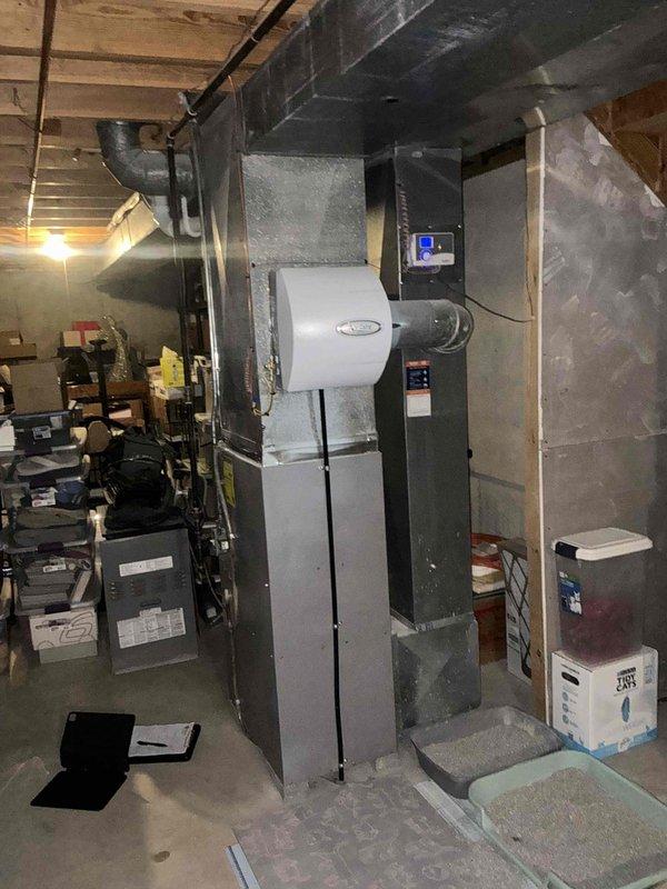 Responded to emergency furnace call and conducted comprehensive equipment assessment. Upon inspection, identified critical failure conditions including severely rusted burner box assembly and compromised heat exchanger showing signs of deterioration. Documented existing system configuration consisting of gray cabinet-style furnace with white PVC venting, integrated humidifier unit, and associated air handling equipment in basement mechanical room. Provided detailed replacement estimate for complete furnace system due to unsafe operating conditions of primary heat exchanger and burner components that pose potential safety hazards and cannot be effectively repaired.