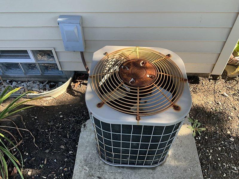 Completed estimate for replacement of aging HVAC system including natural gas furnace and air conditioning unit. The existing furnace, manufactured in 1997 and located in the basement, remains operational but has reached end of service life. The outdoor condenser unit shows visible deterioration with significant rust on fan components and motor mounting areas. Provided comprehensive replacement options for both heating and cooling equipment to address the aging system and improve efficiency and reliability.