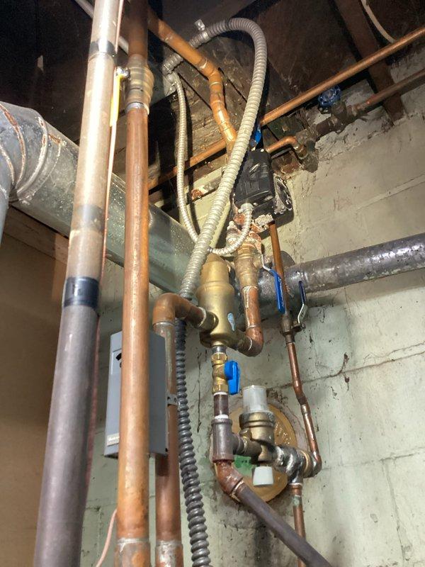Completed HVAC tune-up service on residential heating system. Performed standard maintenance inspection of boiler equipment, expansion tank, circulator pump, and associated plumbing components including copper supply lines, ball valves, and pressure relief systems. All mechanical components photographed and verified operational, with system confirmed functioning within normal parameters.