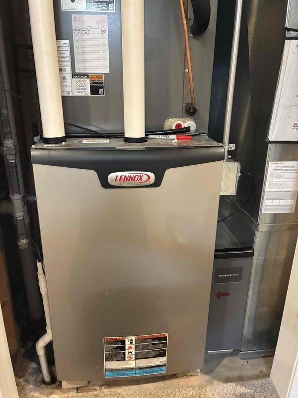 Completed preventive maintenance tune-up on residential Lennox furnace system. Performed standard inspection procedures, checked all operational components, and documented equipment condition with photographic evidence showing the main furnace unit and internal components including heat exchanger and refrigerant lines.
