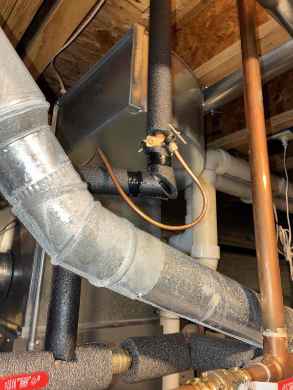 Performed routine heating maintenance visit as part of family membership agreement. Upon arrival, discovered split Aprilaire humidifier tubing requiring immediate attention. Shut off water supply to the humidifier system to prevent water damage and replaced the damaged tubing with new Aprilaire tubing. Inspected HVAC system components including ductwork, copper refrigerant lines, and electrical connections in the attic space. All connections secured and system restored to proper operation.