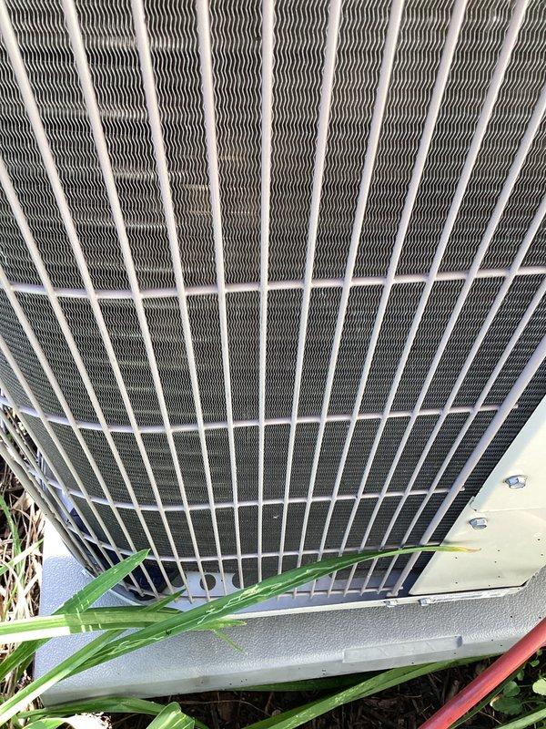 Completed comprehensive furnace and air conditioning tune-up service at residential property. Inspected outdoor condenser unit, finding significant accumulation of grass clippings, leaves, and organic debris around capacitor and electrical components that required removal to prevent airflow restriction and potential component failure. Cleaned condenser coil fins, verified capacitor function and electrical connections, and ensured all wiring terminals were secure and free from corrosion.