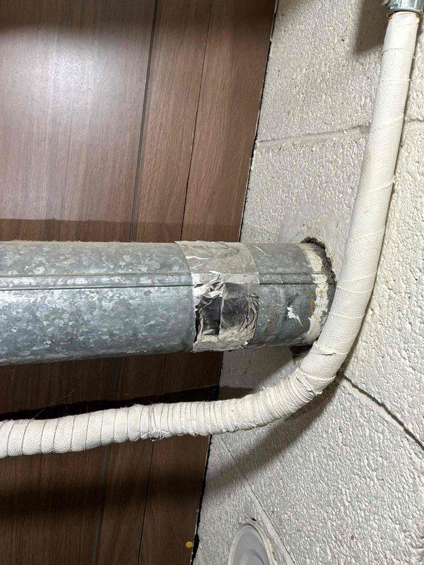 Completed furnace replacement estimate for natural gas unit located in basement. System assessment revealed aging equipment with deteriorated ductwork showing significant surface wear, peeling insulation, and exposed metal sections requiring attention. Documented existing mechanical installation including water heater, ventilation components, and associated plumbing connections for comprehensive replacement planning.