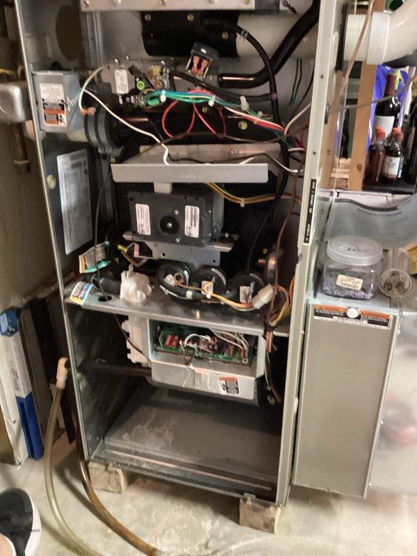 Completed comprehensive furnace tune-up and safety inspection. Removed and examined condensate drain trap assembly, which showed moderate buildup and discoloration requiring cleaning. Performed full system inspection including internal components, electrical connections, control board, and gas valve assembly. Verified all wiring connections were secure, checked burner assembly operation, and confirmed proper airflow throughout the system. All components found to be functioning within manufacturer specifications upon completion.