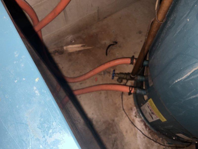 Responded to emergency call for leaking Burnham boiler water tank. Upon arrival, assessed the system and documented existing plumbing infrastructure, including aged brass valves, piping assembly, and compromised tank condition. Provided estimate for complete boiler replacement to resolve the active water leak and prevent further system failure.