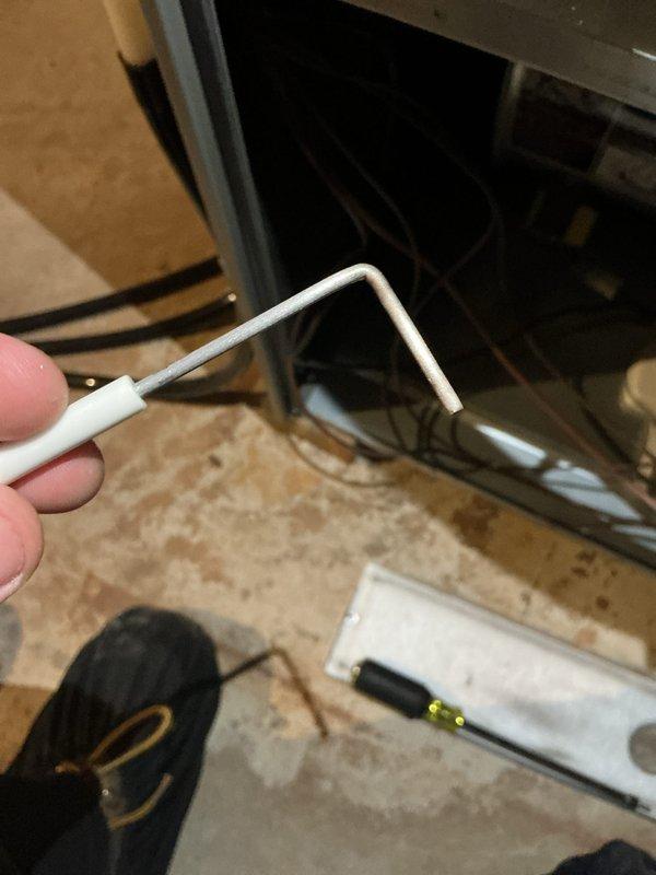 Completed comprehensive tune-up service on HVAC system, including inspection of control board wiring and electronic components within the unit housing. Documented existing wiring configuration showing multiple circuit boards with various colored wire connections; inspected condensate drain line assembly with 90-degree elbow fitting to ensure proper drainage function.