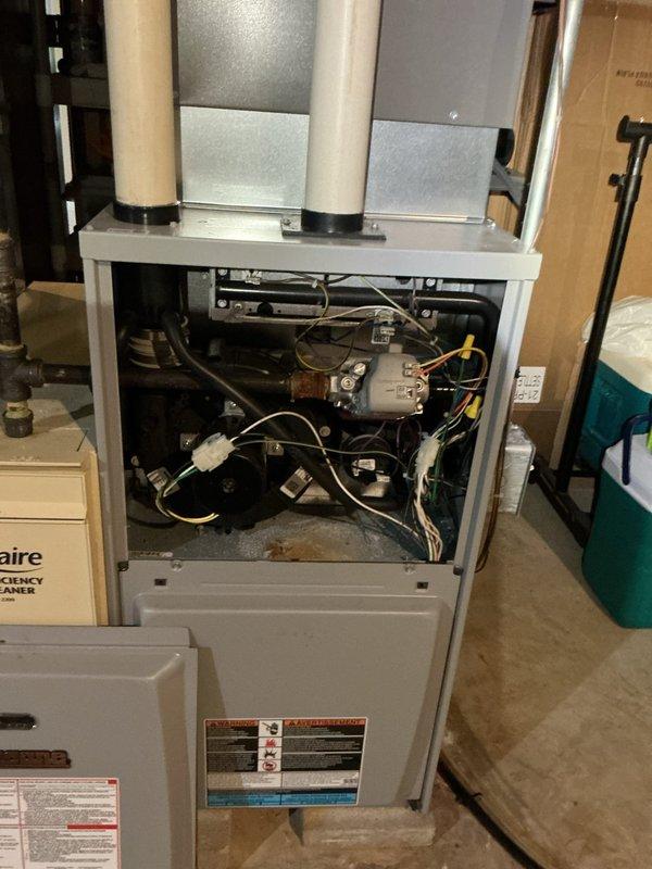 Completed comprehensive heating tune-up and safety inspection on 15-year-old residential furnace unit. Performed standard maintenance protocol including visual inspection of blower motor assembly, electrical connections, control boards, and heat exchanger; verified proper operation of PVC vent and intake piping system; checked all wire terminations and safety controls. All components found operating within normal parameters; unit photographed and returned to service.