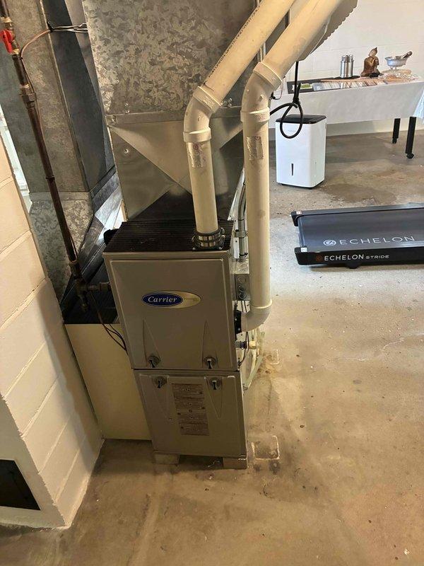 Completed seasonal tune-up maintenance on Carrier furnace system and inspected Air Bear media air filter, which showed signs of contamination and requires replacement. Performed standard system diagnostics and verified proper operation of all HVAC equipment in basement mechanical room including furnace, ductwork connections, and auxiliary environmental control units.