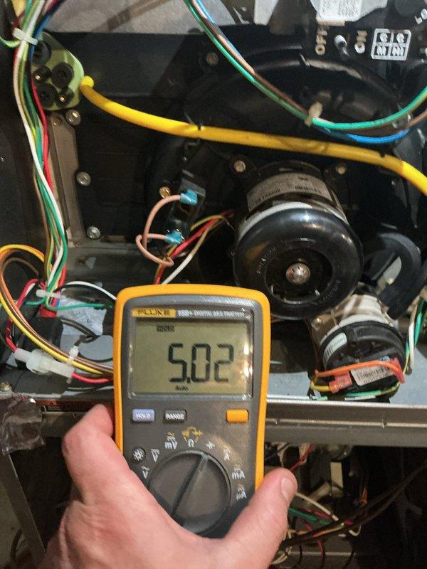 Responded to no-heat call on heating system over 10 years old with reported hole in unit and carbon monoxide concern. Upon arrival, performed comprehensive system diagnostics using digital multimeter to test electrical components and verify proper voltage readings throughout the control circuit. Measured voltage at burner assembly and control module, obtaining readings of 490-502 volts AC, indicating proper transformer output to gas valve and ignition system.

Conducted thorough visual inspection of heat exchanger and burner assembly for cracks, holes, or deterioration that could allow carbon monoxide leakage into living space. Examined all accessible sections of heat exchanger, flue pipe connections, and combustion chamber for structural integrity. Inspected flexible flue coupling and metal clamp connections for proper seal and secure attachment to white cylindrical vent pipe.

Tested all safety controls including limit switches, flame sensor, and pressure switches to ensure proper op