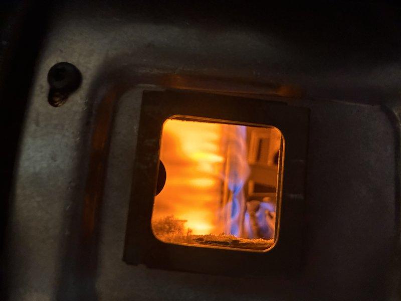 Responded to service call for pilot light failure on Patterson brand tanked water heater. Upon arrival, performed diagnostic evaluation of the unit's gas control system and burner assembly. Pilot light would not remain lit, indicating potential issues with thermocouple, gas valve, or pilot assembly components. Inspected combustion chamber through observation window and confirmed proper flame characteristics when manually lit, with blue-tipped flames indicating adequate air-fuel mixture. Examined copper gas supply piping and connections for integrity and proper gas flow. Assessed overall condition of water heater including venting system and safety controls. Unit showed signs of age with oxidation present on copper piping. Completed diagnostic assessment to determine root cause of pilot light failure and provided recommendations for necessary repairs to restore proper operation of the water heating system.