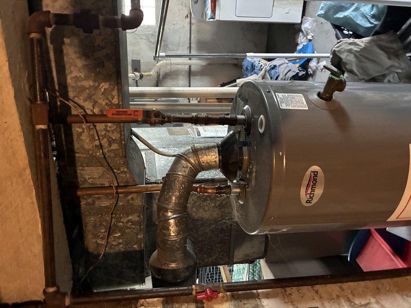 Responded to service call for pilot light failure on Patterson brand tanked water heater. Upon arrival, performed diagnostic evaluation of the unit's gas control system and burner assembly. Pilot light would not remain lit, indicating potential issues with thermocouple, gas valve, or pilot assembly components. Inspected combustion chamber through observation window and confirmed proper flame characteristics when manually lit, with blue-tipped flames indicating adequate air-fuel mixture. Examined copper gas supply piping and connections for integrity and proper gas flow. Assessed overall condition of water heater including venting system and safety controls. Unit showed signs of age with oxidation present on copper piping. Completed diagnostic assessment to determine root cause of pilot light failure and provided recommendations for necessary repairs to restore proper operation of the water heating system.
