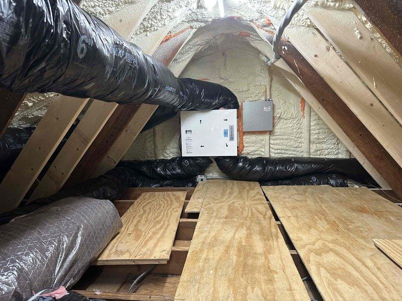 Completed ERV installation warranty inspection in residential attic space. Verified proper installation of energy recovery ventilator unit and associated ductwork system. Documented existing HVAC infrastructure including large-diameter flexible ducts with metallic insulation, spray foam wall insulation, and reflective foil-faced roof insulation. Confirmed all ductwork connections are secure, properly insulated, and sealed. Inspected electrical connections to junction box and conduit routing. Verified adequate clearances around equipment and ductwork per manufacturer specifications. System operational and performing within normal parameters.