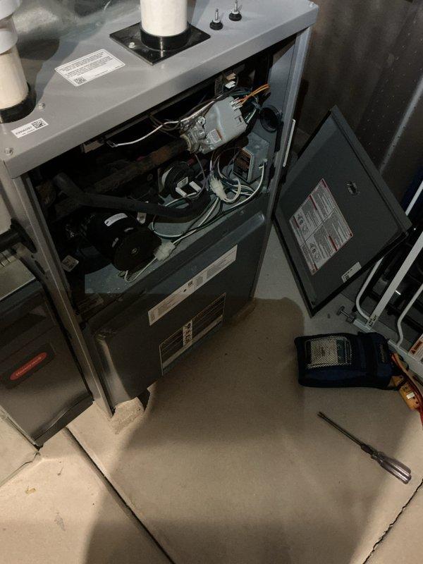 Performed prepaid maintenance visit on residential HVAC system. Cleared and blew out condensate drain line for air conditioning unit, noting rust present in drain assembly. Opened furnace access panel to inspect internal components including blower motor, gas valve assembly, and electrical connections. Verified proper operation of heating system as part of recurring membership maintenance service.