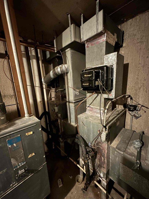 Conducted on-site estimate for air handler replacement in hallway closet location. Assessed existing aging HVAC system in basement utility area, documented current equipment configuration including furnace unit, ductwork connections, electrical panels, and associated plumbing lines to determine proper sizing and installation requirements for new air handler placement.