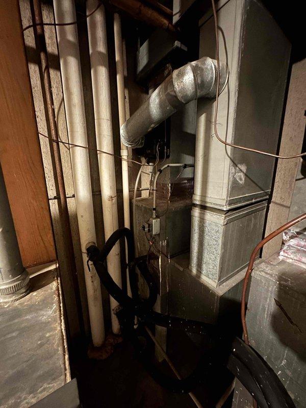 Conducted on-site estimate for air handler replacement in hallway closet location. Assessed existing aging HVAC system in basement utility area, documented current equipment configuration including furnace unit, ductwork connections, electrical panels, and associated plumbing lines to determine proper sizing and installation requirements for new air handler placement.