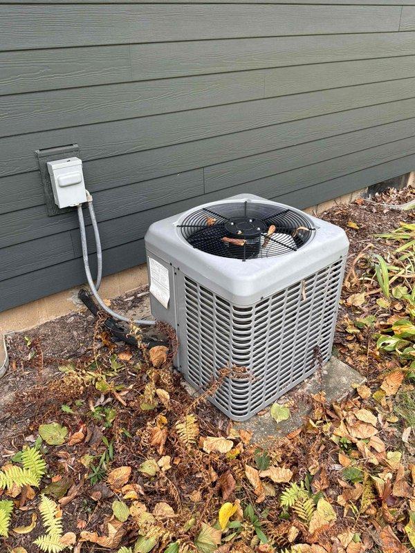 Completed on-site evaluation of existing natural gas furnace and air conditioning system located in basement. Both units are operational but aging and nearing end of serviceable life. Documented current equipment configuration including outdoor condensing unit on concrete pad with proper electrical disconnect, and basement-mounted furnace with existing ductwork infrastructure. Provided comprehensive replacement estimate for new high-efficiency furnace and AC system to homeowner.