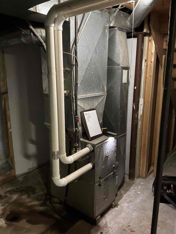Completed on-site estimate for furnace replacement in basement mechanical room. Assessed existing furnace unit, ductwork configuration, PVC condensate drainage system, and surrounding installation space to provide comprehensive replacement recommendations for customer requesting expedited service.