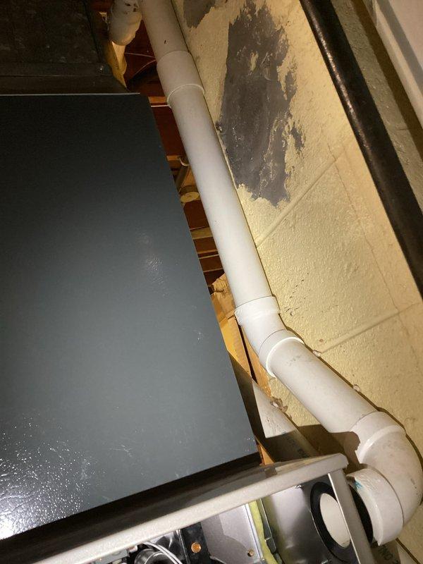 Completed scheduled prepaid heating maintenance visit on residential HVAC system. Performed comprehensive inspection of air handler unit and internal components including blower motor assembly, electrical connections, and control systems. All wiring connections were verified secure with proper color coding intact. Inspected condensate drain lines and PVC piping routing along wall - noted previous water staining on wall surface but current system operating without active leaks. Blower motor and relay components functioning within normal parameters. System tested and confirmed operational for heating season.