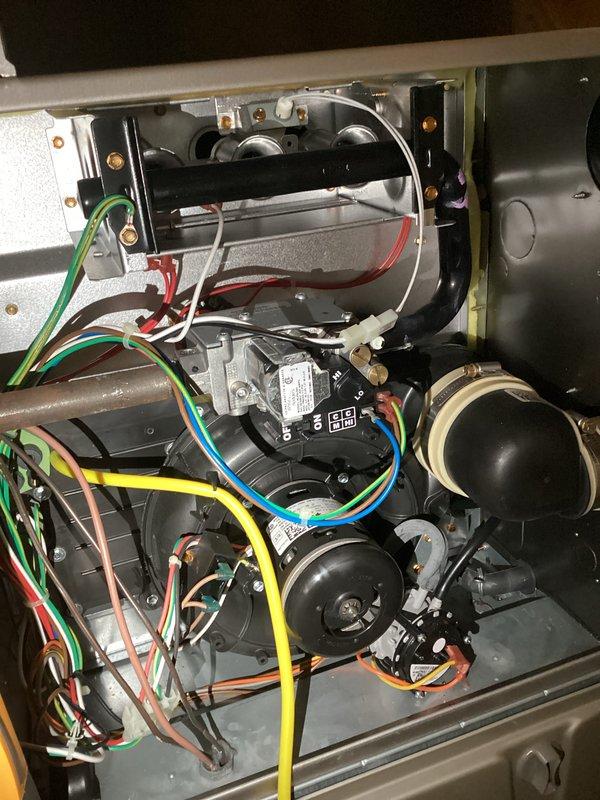 Completed scheduled prepaid heating maintenance visit on residential HVAC system. Performed comprehensive inspection of air handler unit and internal components including blower motor assembly, electrical connections, and control systems. All wiring connections were verified secure with proper color coding intact. Inspected condensate drain lines and PVC piping routing along wall - noted previous water staining on wall surface but current system operating without active leaks. Blower motor and relay components functioning within normal parameters. System tested and confirmed operational for heating season.