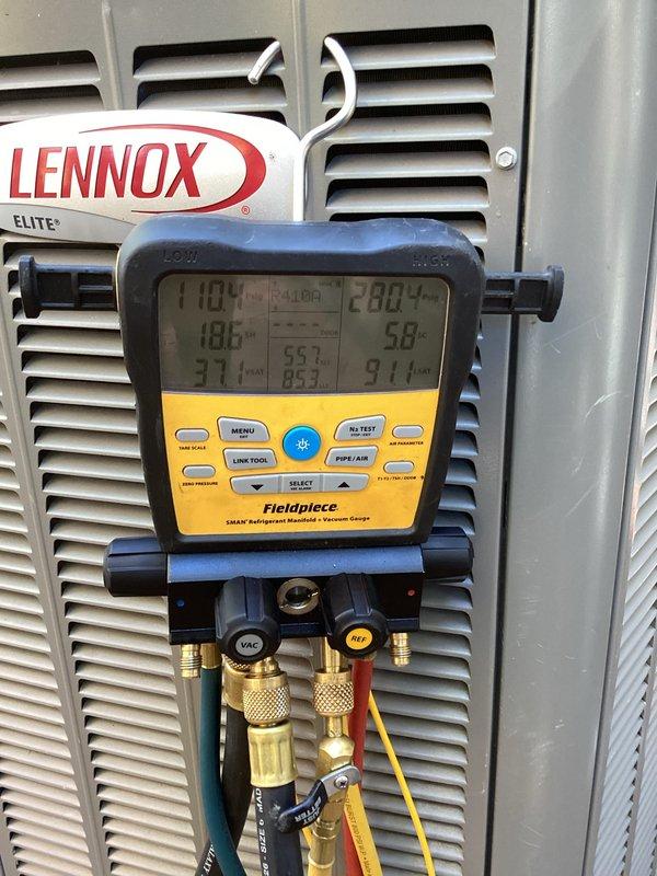 Responded to customer complaint of delayed start on air conditioning unit occurring over several nights. Performed diagnostic evaluation using digital manifold gauges to assess system pressures and temperatures on Lennox Elite unit. Verified thermostat operation and settings, confirming unit communication and proper display function at 65°F current temperature with 70°F setpoint.