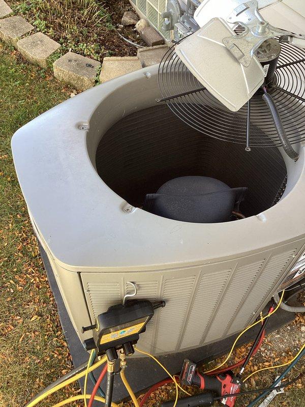 Responded to no cooling callback on residential HVAC system. Upon arrival, connected manifold gauges to outdoor condensing unit and performed system diagnostics. Pressure readings indicated abnormally high head pressure on the high side (687 psig) and elevated suction pressure on the low side (585 psig), with superheat reading of 71°F suggesting potential airflow restriction or system overcharge. Removed top access panel to inspect condenser fan operation and internal components. Based on gauge readings and visual inspection, identified issue preventing proper cooling operation and addressed accordingly to restore system functionality.