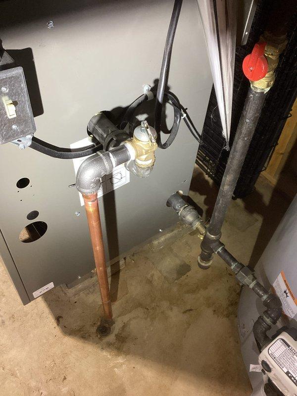 Completed boiler repair work involving replacement of copper piping and fittings on the heating system. Installed new 3/4" couplings and connections using press tool to ensure proper sealing. Replaced brass pressure reducing valve and associated copper pipe sections showing oxidation and wear. Work included vertical pipe runs from boiler unit with proper insulation installation and integration with existing black insulated piping. All connections tested and verified for proper operation upon completion.