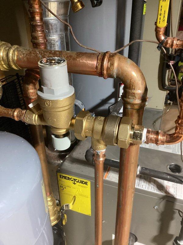 Completed boiler repair work involving replacement of copper piping and fittings on the heating system. Installed new 3/4" couplings and connections using press tool to ensure proper sealing. Replaced brass pressure reducing valve and associated copper pipe sections showing oxidation and wear. Work included vertical pipe runs from boiler unit with proper insulation installation and integration with existing black insulated piping. All connections tested and verified for proper operation upon completion.