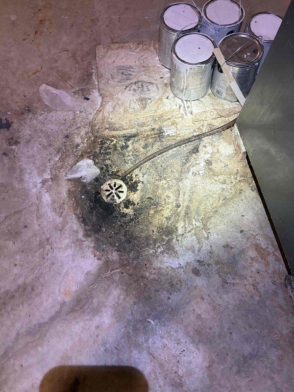 Conducted estimate for replacement of 28+ year old natural gas furnace and air conditioning system located in basement area of tri-level residence. Existing olive-green cabinet-style furnace unit with metal ductwork connections showed age-related wear consistent with equipment at end of service life. Documented current HVAC equipment configuration, ductwork layout, and installation access points for replacement planning. Photographed existing furnace installation, water heater proximity, basement utility room conditions, and floor drain location to assess equipment removal and new system installation requirements.