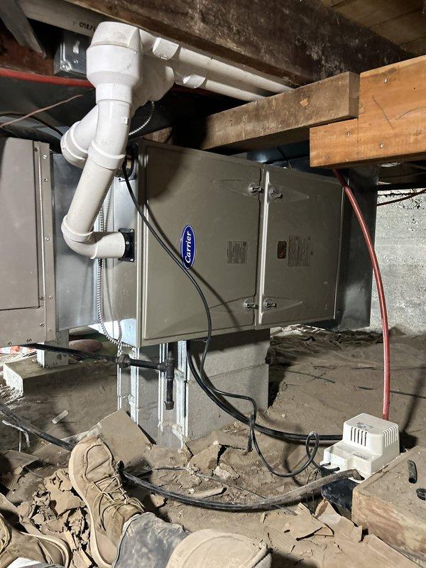 Removed and replaced the existing horizontal gas furnace with a new Carrier unit, set on blocks in the crawl space, reusing the existing filter rack and thermostat. Replaced the existing 2" PVC vent/intake piping with 3" PVC, terminated through the exterior wall, and connected the condensate drain to the condensate pump. Electrical connections were completed under permit, and the old furnace was removed from the site for return to the manufacturer.