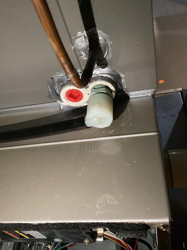 Responded to a water leak at a 16-year-old gas furnace and inspected the condensate drain connection, evaporator coil housing penetration, and refrigerant line set for the source of the moisture. Verified the PVC drain and condensate fittings, resealed the cabinet penetration around the insulated refrigerant line, and confirmed the interior components showed no signs of frost, ice, or corrosion.