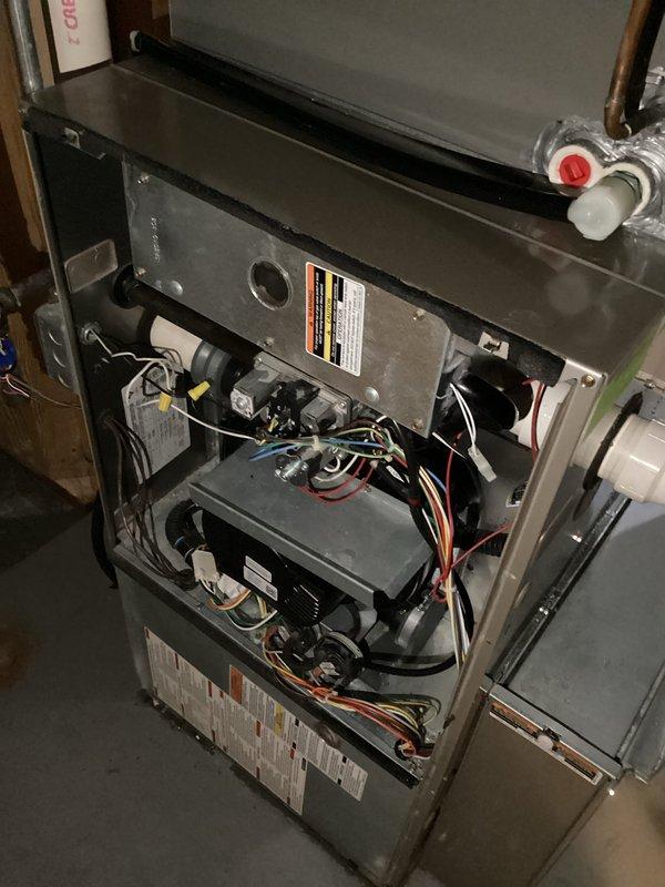 Responded to a water leak at a 16-year-old gas furnace and inspected the condensate drain connection, evaporator coil housing penetration, and refrigerant line set for the source of the moisture. Verified the PVC drain and condensate fittings, resealed the cabinet penetration around the insulated refrigerant line, and confirmed the interior components showed no signs of frost, ice, or corrosion.