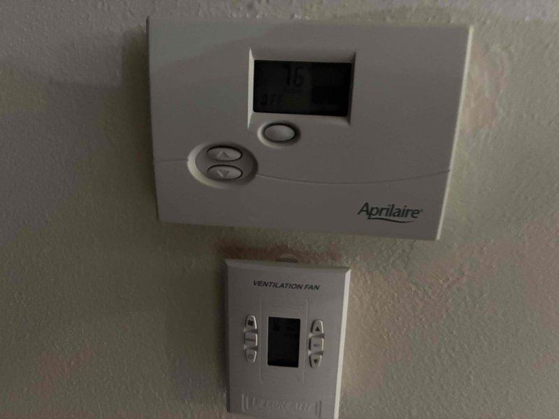 Performed an on-site estimate for proactive replacement of an aging, fully operational gas furnace and air conditioning system located in the basement, currently a 70,000 BTU furnace paired with a 14 SEER AC. Evaluated the existing equipment and associated components, including supply register and duct boot configuration, Aprilaire digital controller, and ventilation fan control, to determine replacement scope and system compatibility.