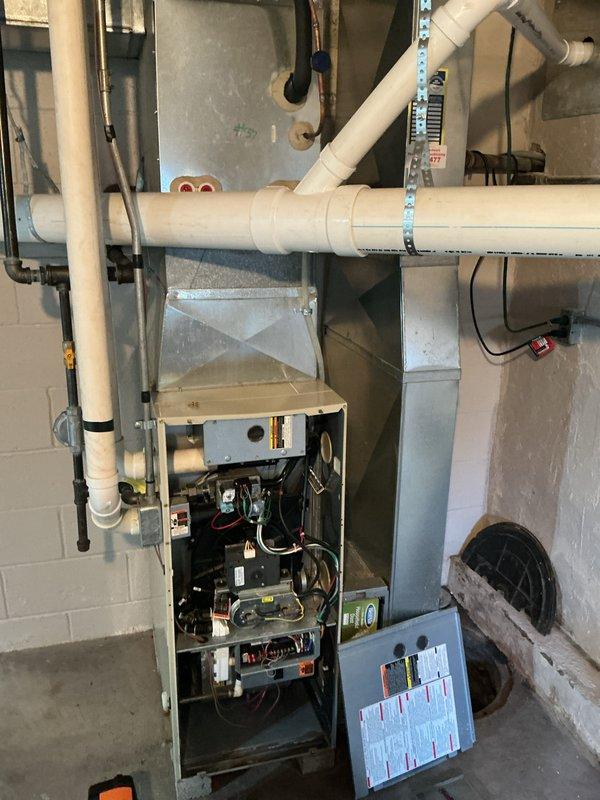 Performed a seasonal furnace tune-up, accessing the burner compartment and control cabinet to inspect the burner assembly, control board, transformer, relays, and low-voltage thermostat terminal connections (W, C, Y, G, HUM) for secure termination and proper wire routing. Verified wiring harness integrity and cleaned accumulated dust and debris from the cabinet interior, then reinstalled the access panel and confirmed the unit was ready for operation.