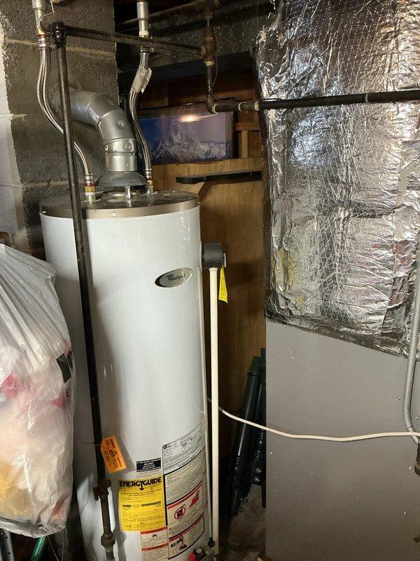 Diagnosed a no-hot-water complaint on a gas-fired tank water heater where the pilot would light briefly but fail to stay lit, inspecting the unit, gas supply piping, flexible connectors, and galvanized vent connection with no visible leaks, corrosion, or venting obstructions. Performed repair to restore reliable pilot and burner operation, then relit the appliance and verified sustained flame and proper draft. System is operating normally and producing hot water.