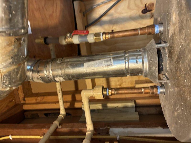Responded to a no-hot-water complaint with discolored water at the toilet and inspected the Rheem tank-style water heater, including the copper supply lines, isolation ball valve, dielectric/union fittings, CPVC connections, flue venting, and drain piping. The discolored water and loss of hot water indicate internal tank deterioration and sediment or corrosion buildup, so the unit was serviced to restore hot water delivery and system operation. Verified that water connections, venting, and the surrounding mechanical area were secure and in working order upon completion.