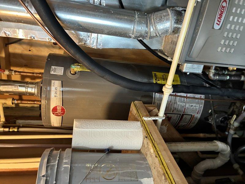 Responded to a no-hot-water complaint with discolored water at the toilet and inspected the Rheem tank-style water heater, including the copper supply lines, isolation ball valve, dielectric/union fittings, CPVC connections, flue venting, and drain piping. The discolored water and loss of hot water indicate internal tank deterioration and sediment or corrosion buildup, so the unit was serviced to restore hot water delivery and system operation. Verified that water connections, venting, and the surrounding mechanical area were secure and in working order upon completion.
