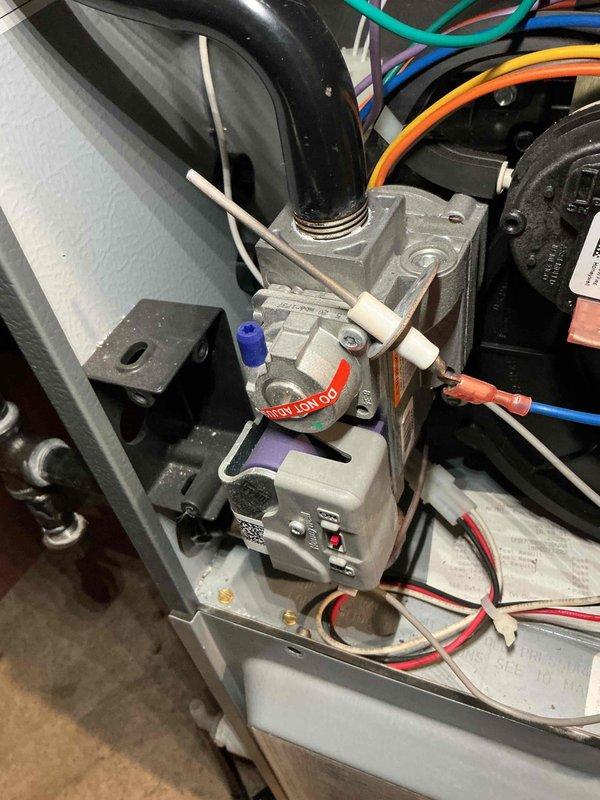 Performed a furnace tune-up, inspecting the gas valve assembly, flame sensor/igniter, wiring connections, and inducer motor housing, all of which showed light dust and normal wear with no signs of rust, frost, or breakage. Verified system operation and measured a supply air temperature of 122.5°F at the register, confirming the unit is heating normally.