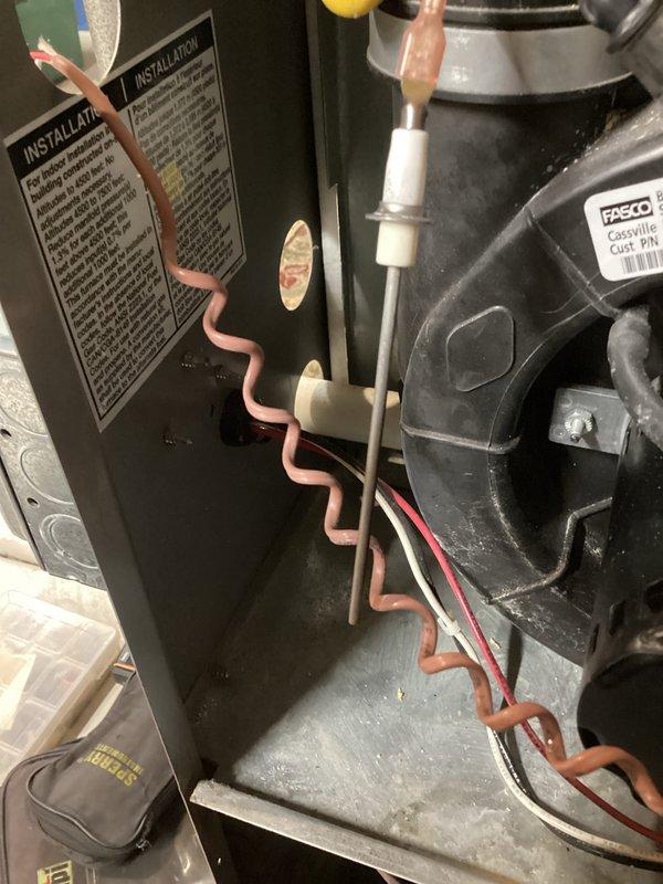 Performed a furnace tune-up, inspecting the blower assembly, flame sensor, and control wiring within the cabinet and checking system operation with a digital multimeter. Cleaned accumulated dust and debris from the cabinet interior and verified connections and components were in proper working condition.