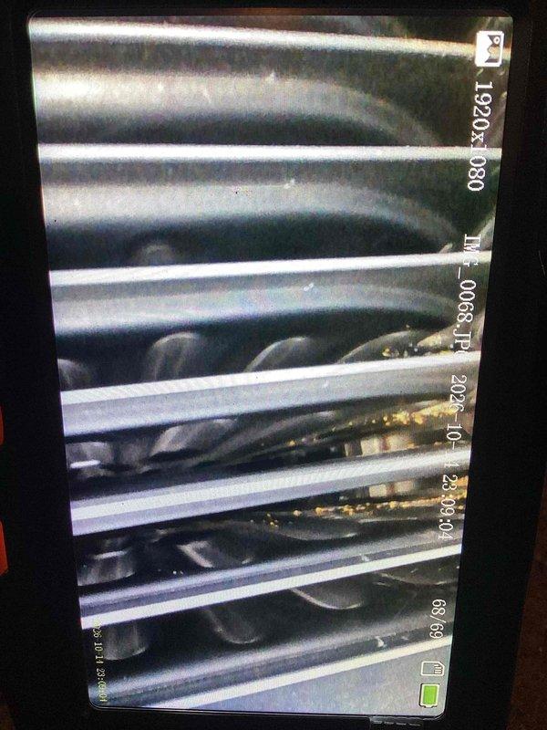 Performed tune-ups on two furnaces, including inspection of the heat exchanger and blower assembly with a borescope camera, which revealed light debris and residue buildup on the blower wheel and heat exchanger surfaces. Cleaned and tested both units for proper operation, and installed a new thermostat.