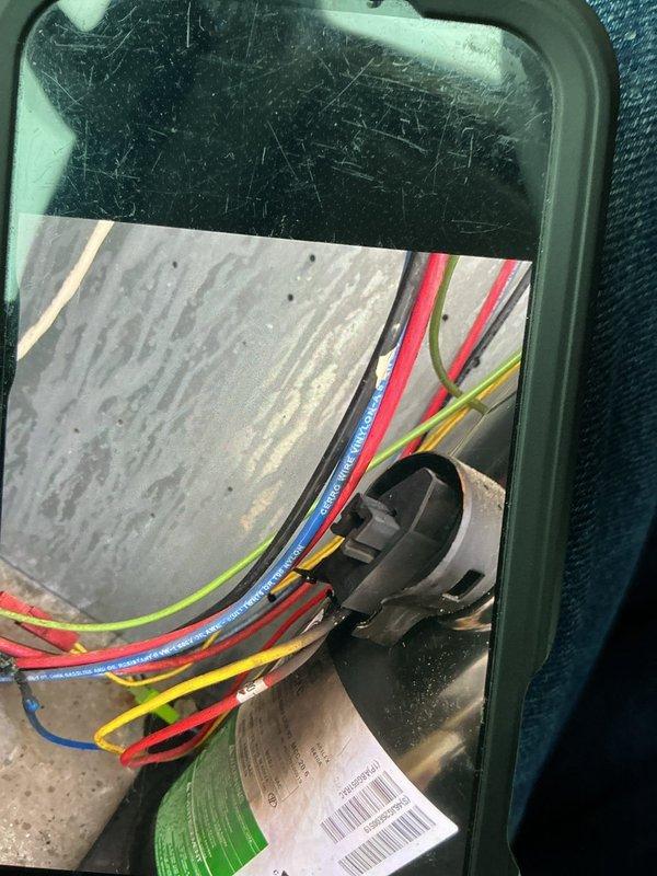 Responded to a no-cool call on a 10+ year old rooftop unit and traced the fault to the economizer, which was not responding to control signals. Inspection of the economizer control wiring revealed scorched, charred wire splices and burnt conductor ends with soot residue, indicating overheated connections and damaged wiring. Documented the damaged wiring and failed connections with photos and identified the burnt wiring as the cause of the economizer failure and loss of cooling.