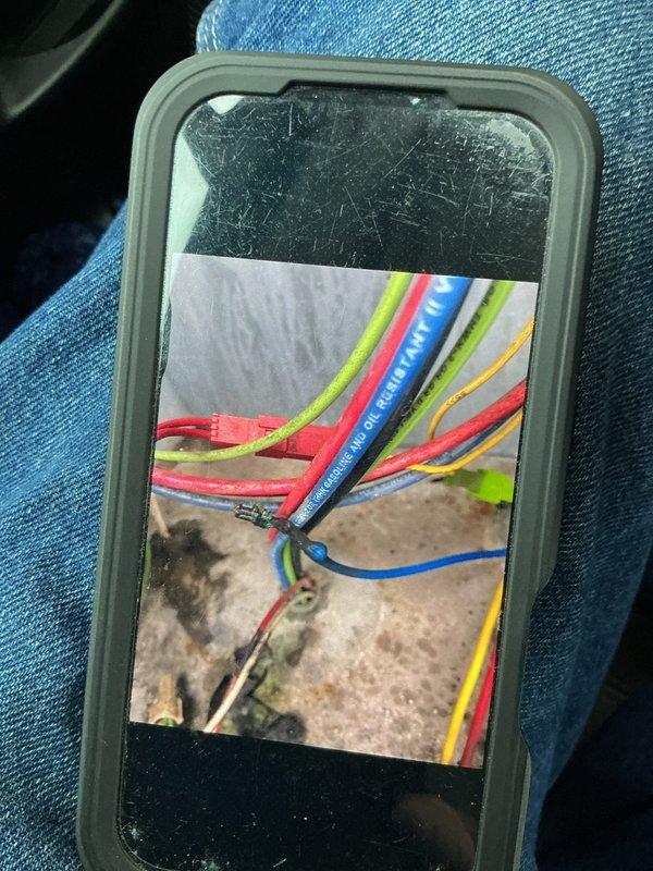 Responded to a no-cool call on a 10+ year old rooftop unit and traced the fault to the economizer, which was not responding to control signals. Inspection of the economizer control wiring revealed scorched, charred wire splices and burnt conductor ends with soot residue, indicating overheated connections and damaged wiring. Documented the damaged wiring and failed connections with photos and identified the burnt wiring as the cause of the economizer failure and loss of cooling.