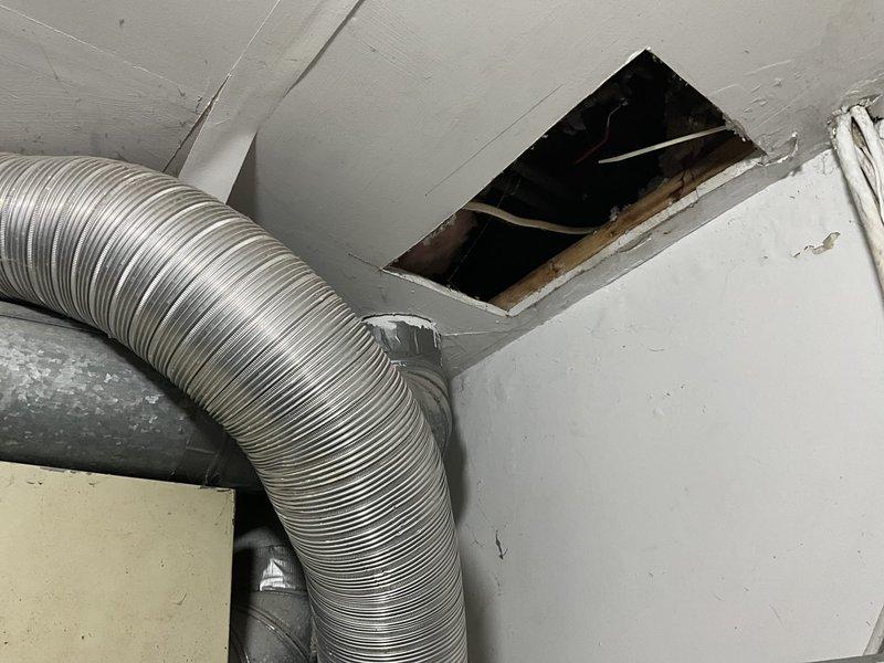 Performed an on-site evaluation for replacement of the original 1987 heating system, with the homeowner interested in upgrading to a heat pump or the best-suited option for the home. Inspected the existing flex duct and galvanized plenum connections, noting worn, foil-taped ductwork and a cut ceiling access opening, and verified the existing 30-amp double-pole breaker serving the equipment to assess electrical capacity for the new system. Findings will be used to recommend an appropriately sized, energy-efficient heat pump replacement and any necessary duct and electrical modifications.