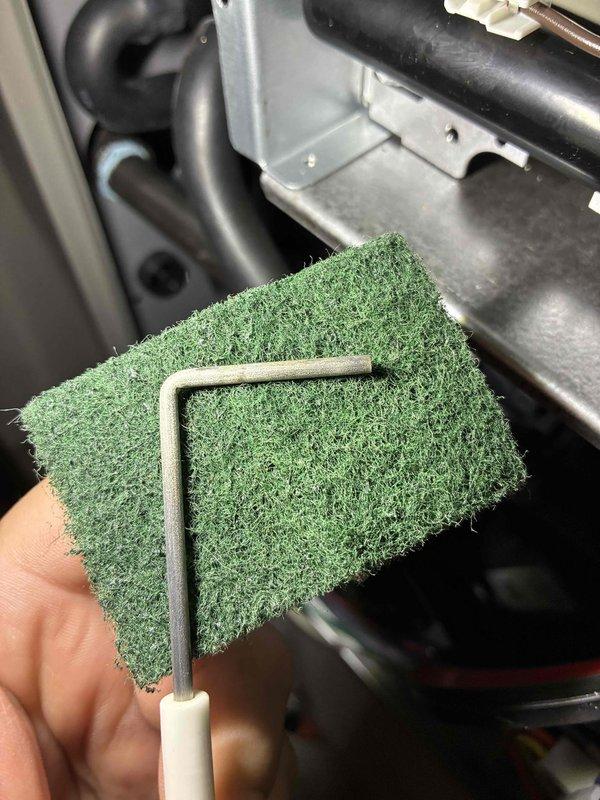 Performed scheduled furnace preventive maintenance under the recurring service agreement, including removal and cleaning of the flame sensor with an abrasive pad to eliminate oxidation buildup and restore reliable flame proving. Inspected and replaced the heavily dust-loaded return air filter to restore proper airflow, and evaluated thermostat operation in response to the customer's concern.